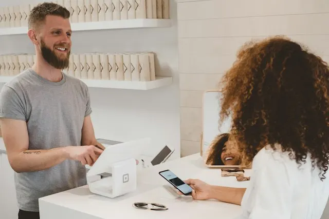 Small business owner serving a customer